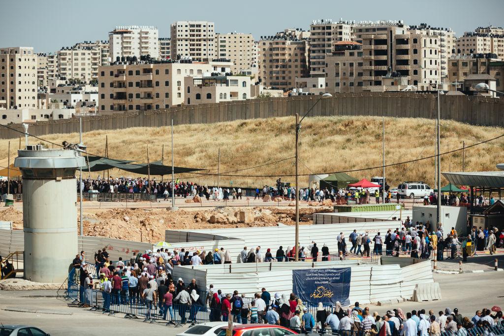 Palestinians queue at Qalandiya checkpoint on Friday during Ramadan, seeking access to Jerusalem, 2019