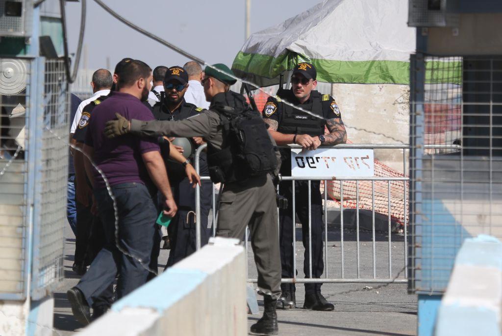 Israeli security forces refuse a Palestinian man entry to Jerusalem at the Qalandiya checkpoint during Ramadan