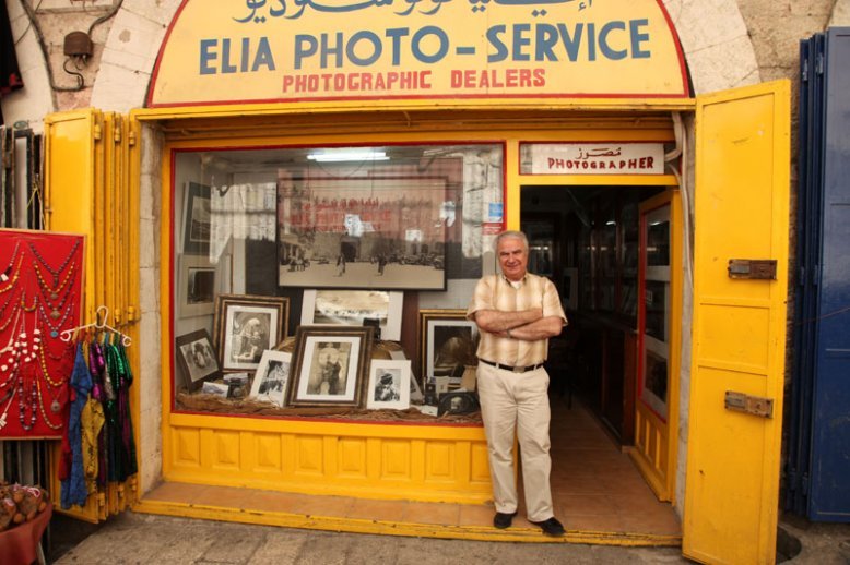 Photographer Kevork Kahvedjian outside the Elia photo shop in Jerusalem's Old City