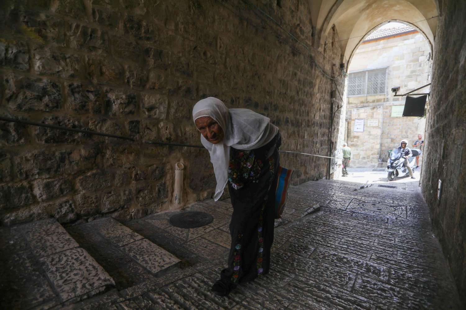 An elderly woman in a tunnel in the Old City of Jerusalem, 2021