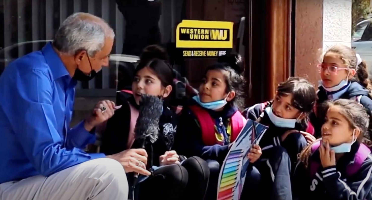 Storyteller Husam Abu Eisheh interviews schoolchildren for the Nas wa Hurras program in Jerusalem, April 16, 2021