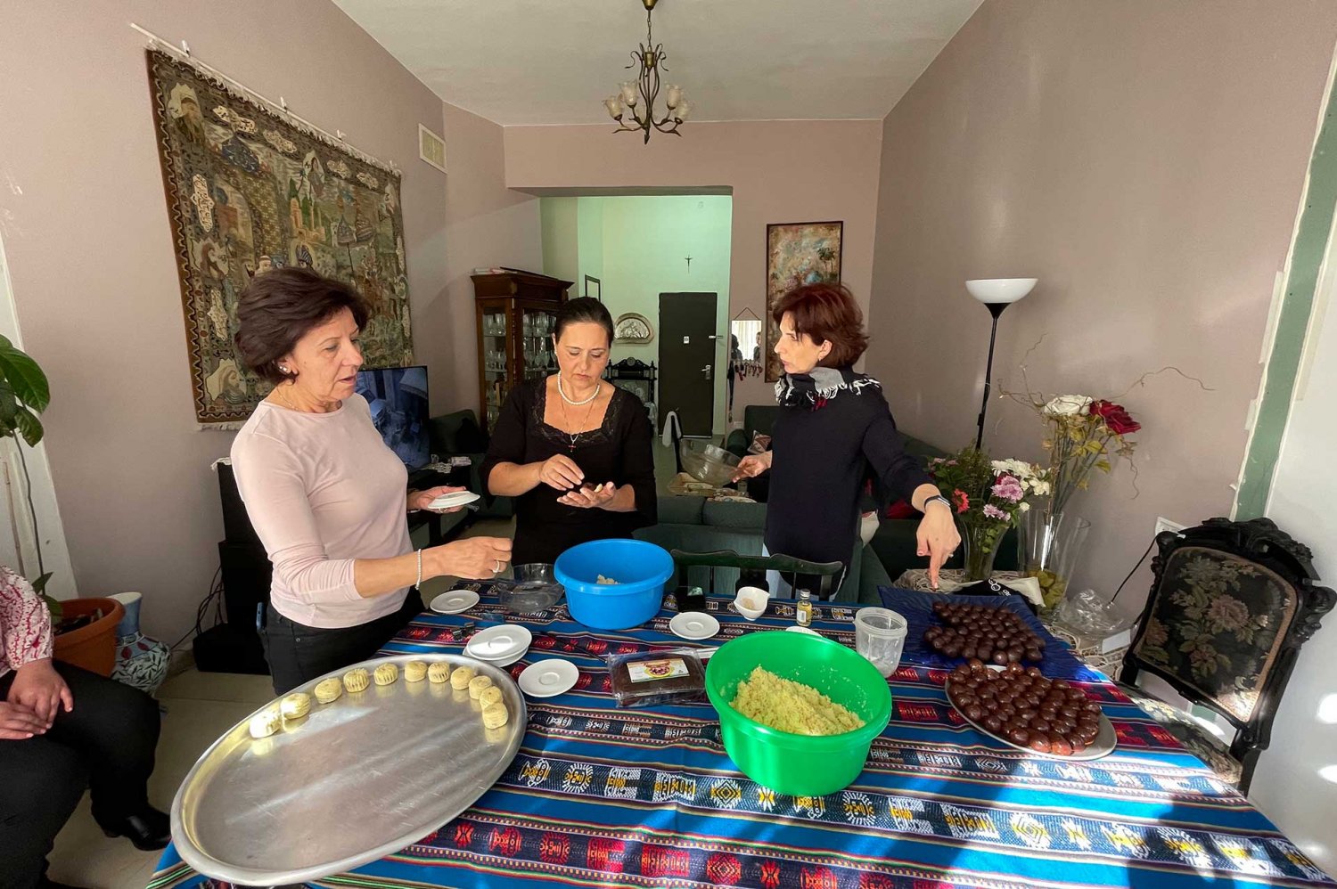 Three Palestinian woman make Middle Eastern pastries at a home in Jerusalem