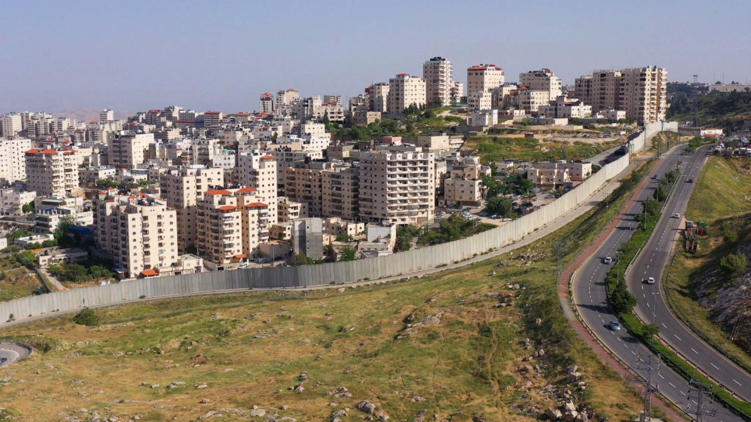Shu'fat refugee camp and the Israeli settlement of Pisgat Ze'ev, divided by the Separation Wall