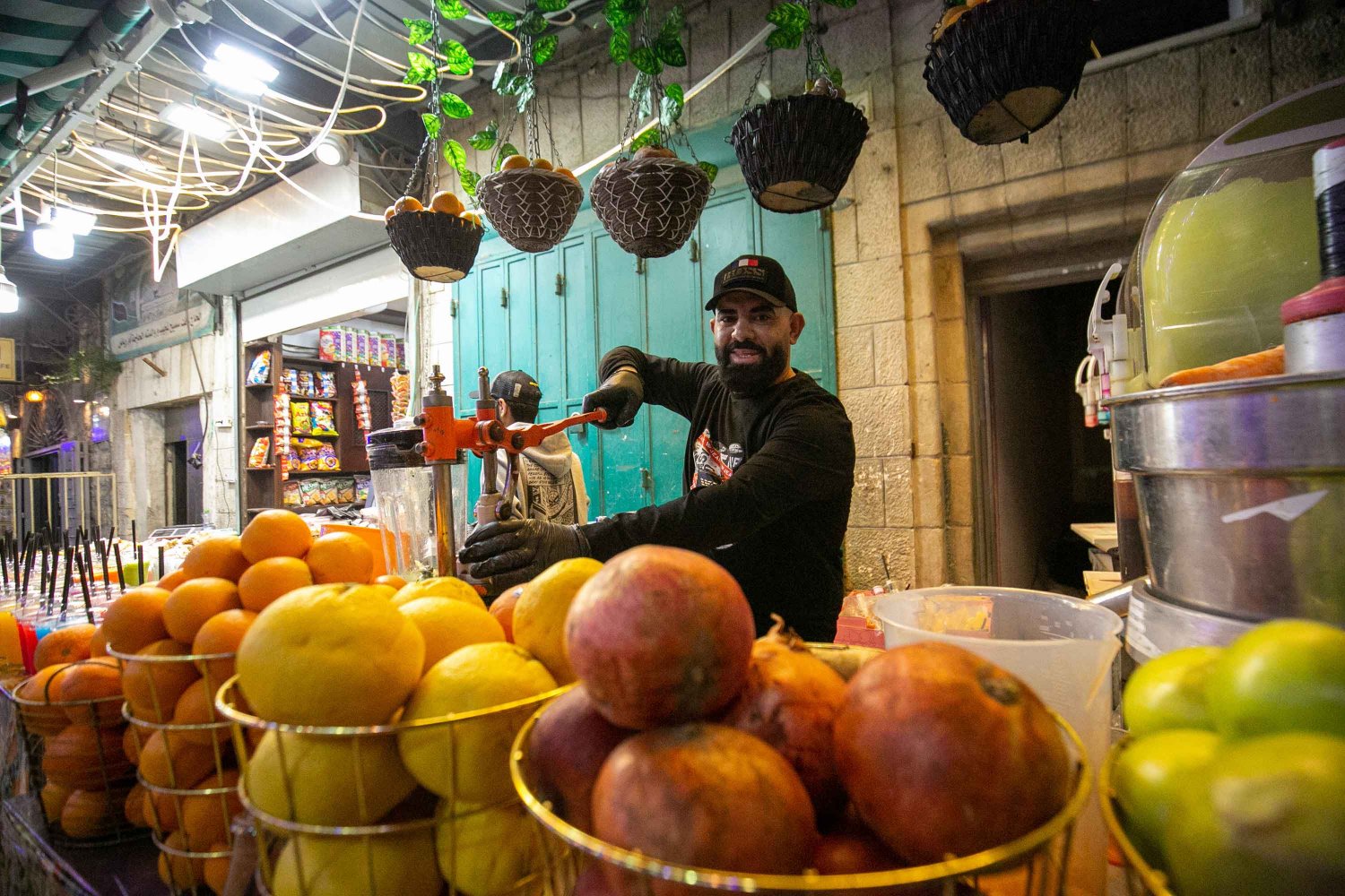 A vendor prepares a fresh glass of fruit in the Old City of Jerusalem during Ramadan 2022