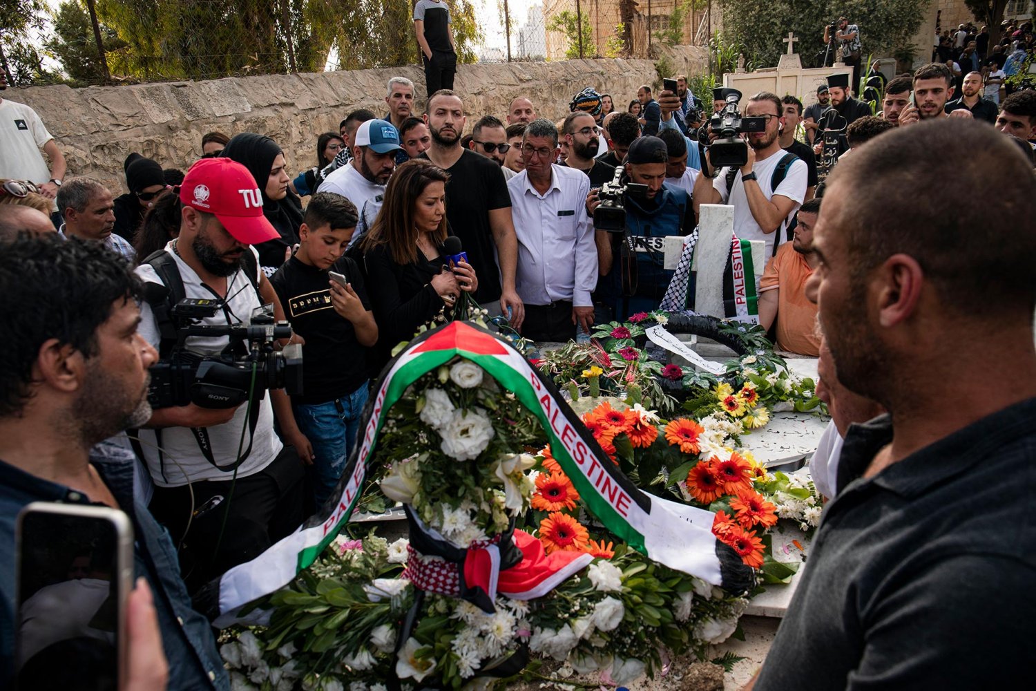 Mourners at the grave of Shireen Abu Akleh in Mount Zion cemetery in Jerusalem, 2022
