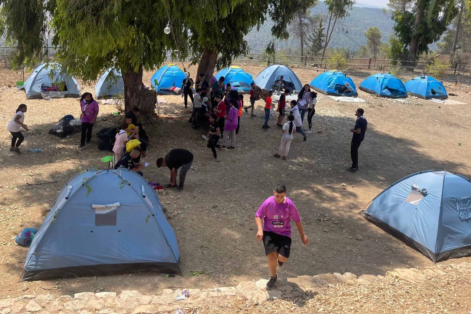 Campers learn to pitch their own tents during “Silwan Summer 2022,” a youth camp for the al-Bustan district scout group, 2022
