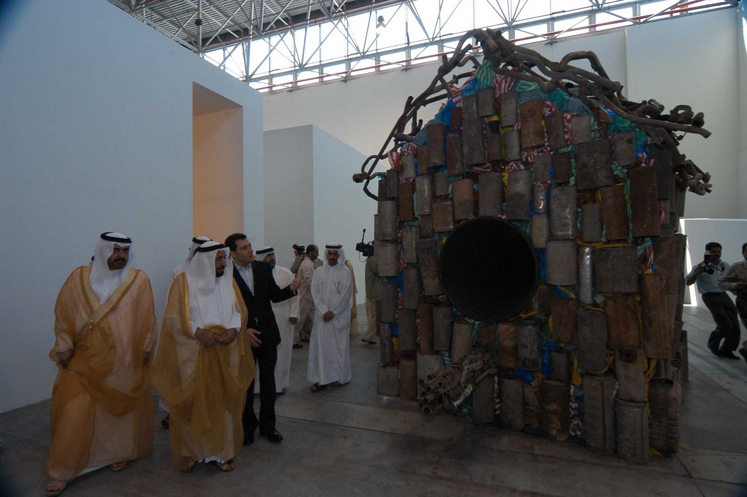 Curator Jack Persekian shows H.H. Sheikh Sultan Al Qasimi the work of Nari Ward at the Sharjah Biennial 2005.