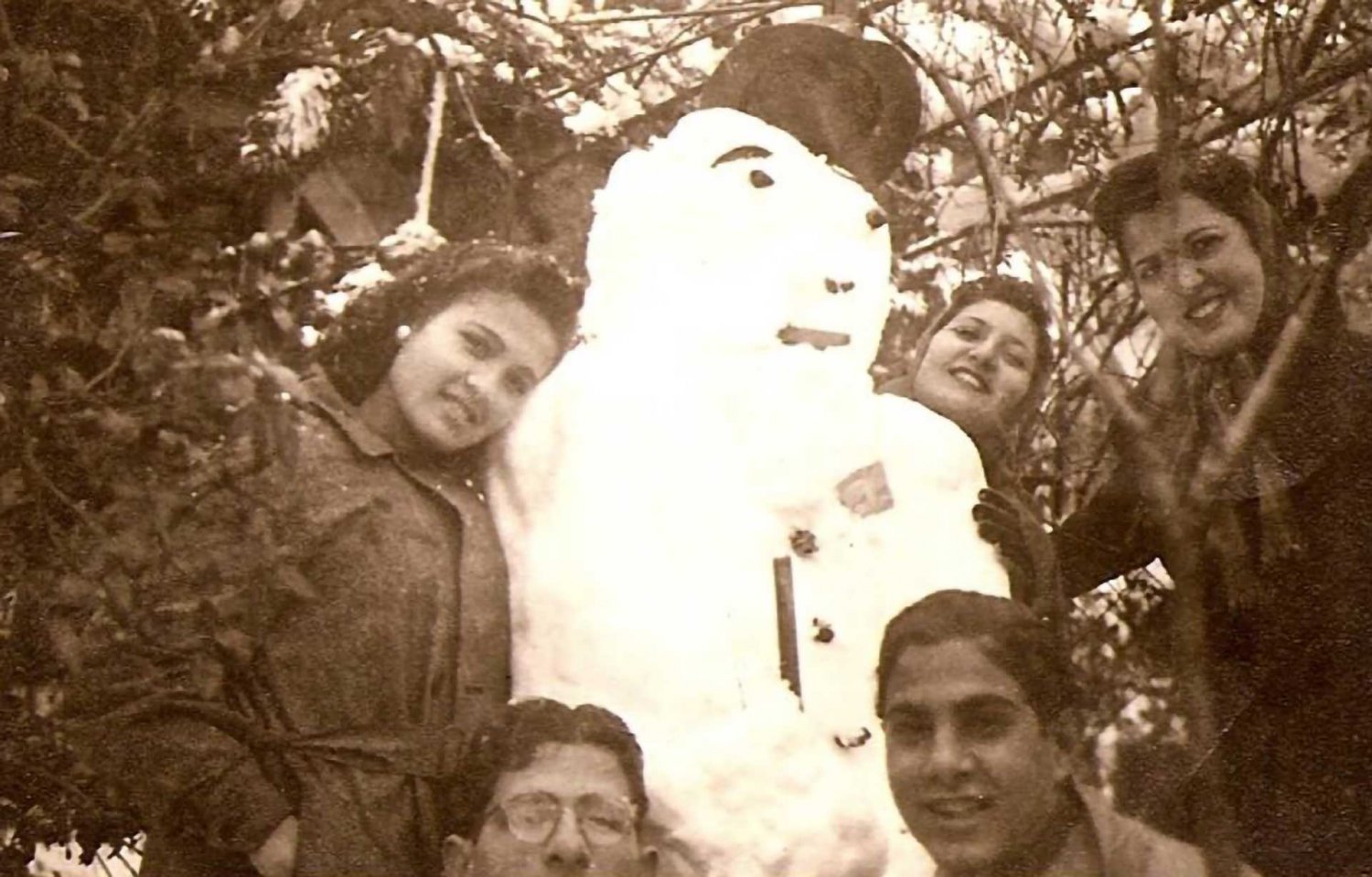 Zakia Jabre and friends build a snowman in Jerusalem, 1940s.