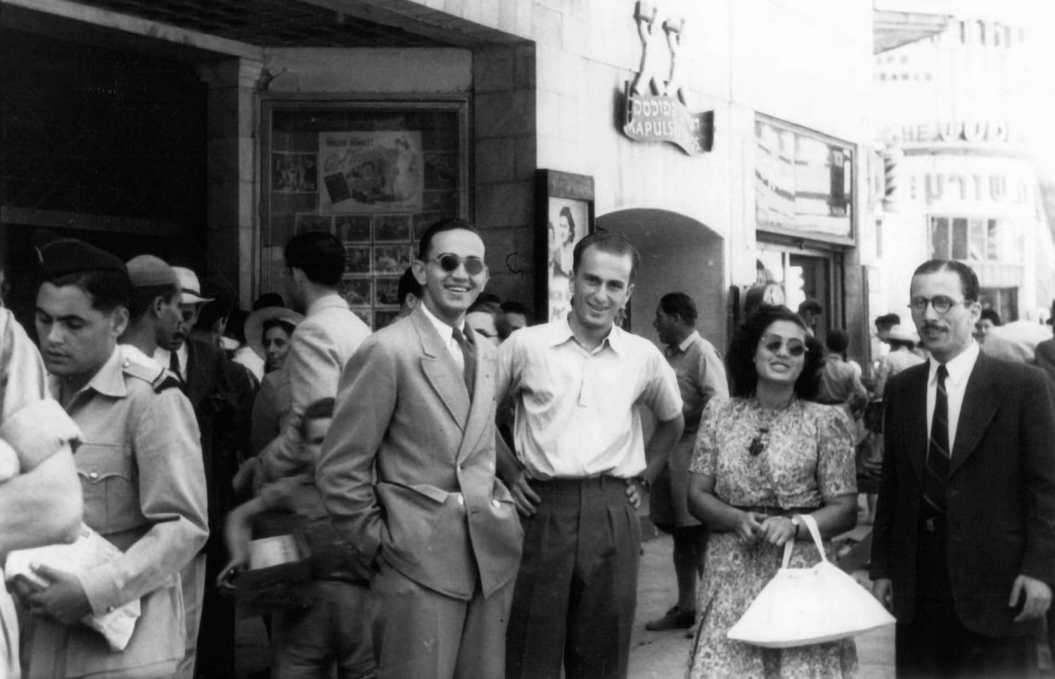 Jack Sinunu, Elias Mushabek, Zakia Jabre, and Eftime Acra in front of Zion Cinema, Jerusalem, 1940s