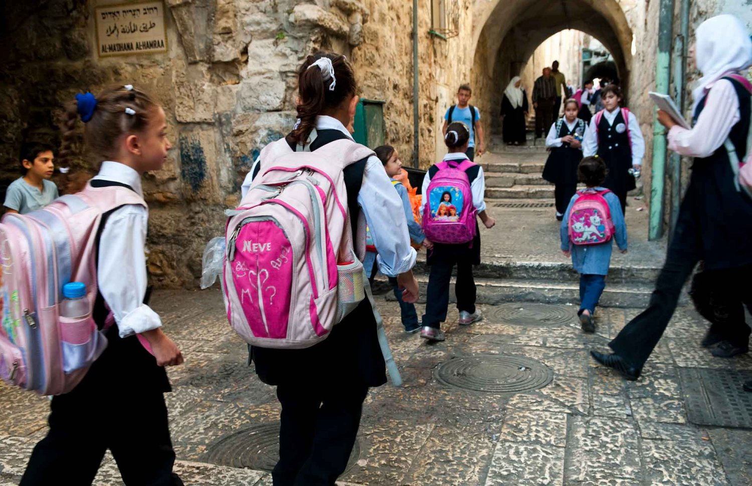 Children carrying schoolbags walking in the Jerusalem Old City