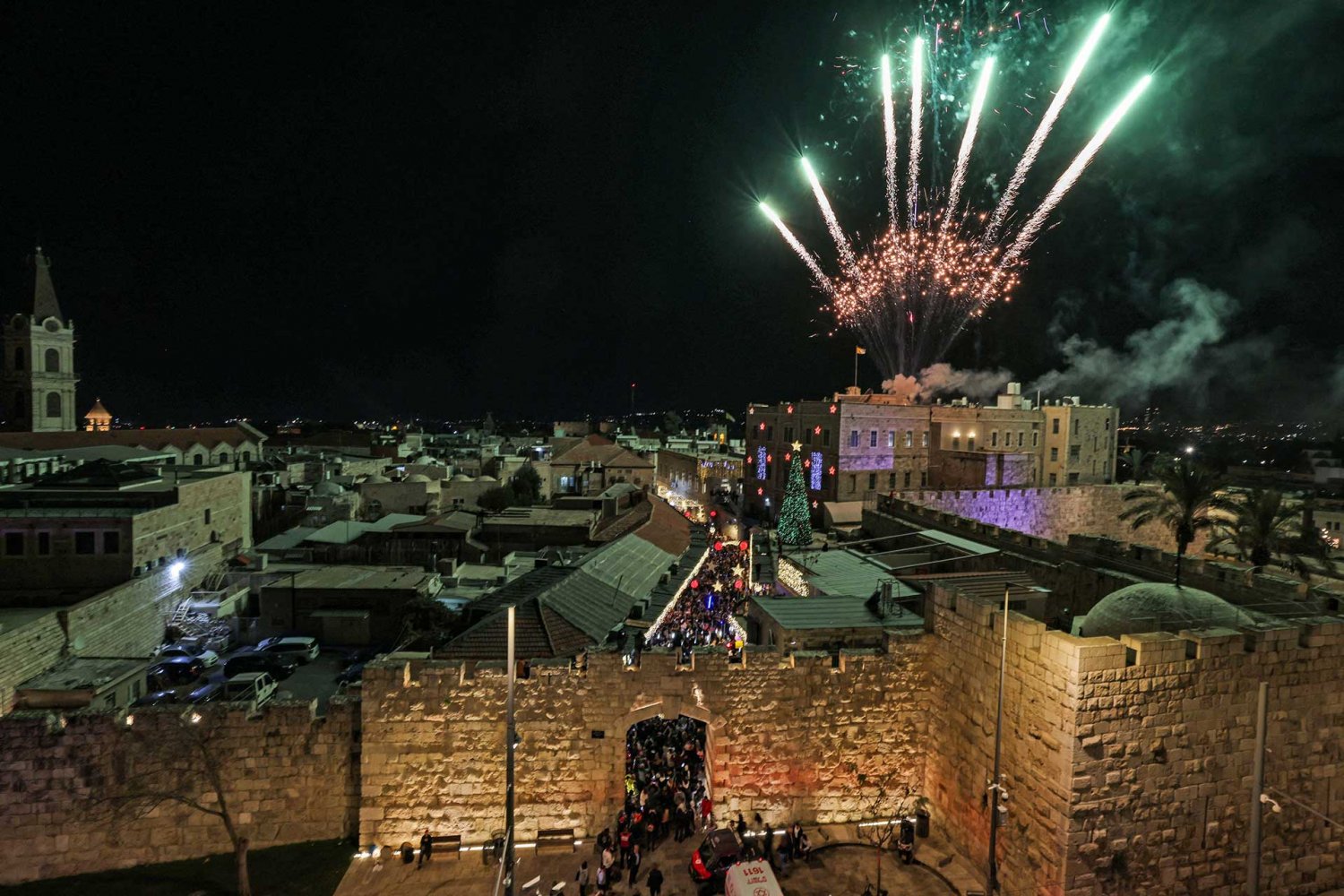 Fireworks illuminate the sky to mark the Christmas tree lighting inside Jerusalem's Old City, December 11, 2022.