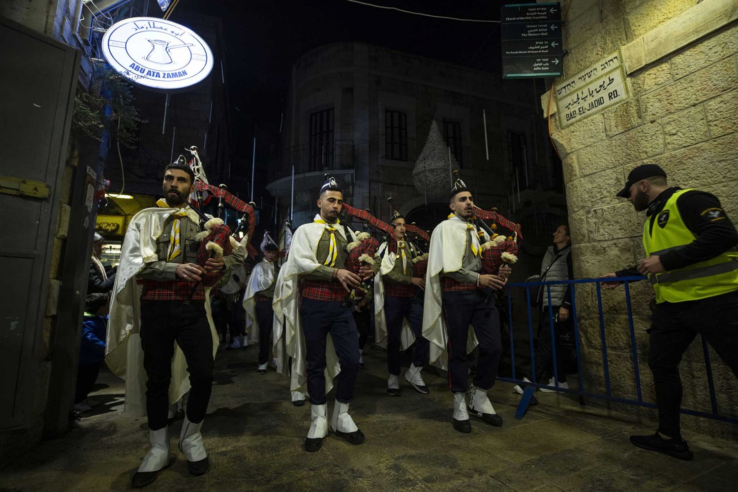 Bagpipers parade in the Old City of Jerusalem during a Christmas celebration