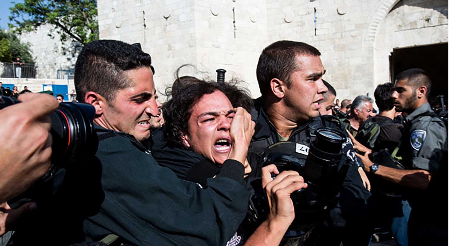 Israeli soldiers arrest a PalIsraeli border policemen arrest a Palestinian photographer on ‘Jerusalem Day’ at Damascus Gate, East Jerusalem, May 8, 2013.