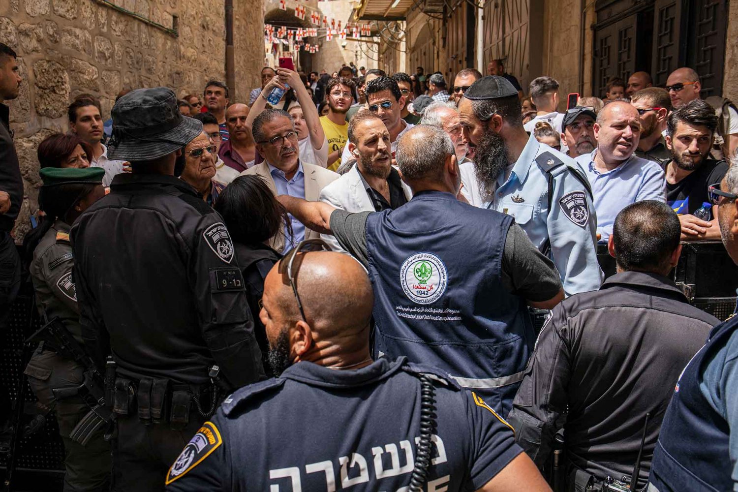 Israeli police try to force a woman back at the entrance to the Church of the Holy Sepulchre, Great Saturday, 2023.