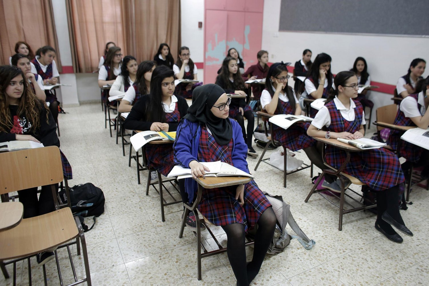 Classroom of Palestinian students in uniforms at Rosary Sisters School in Beit Hanina