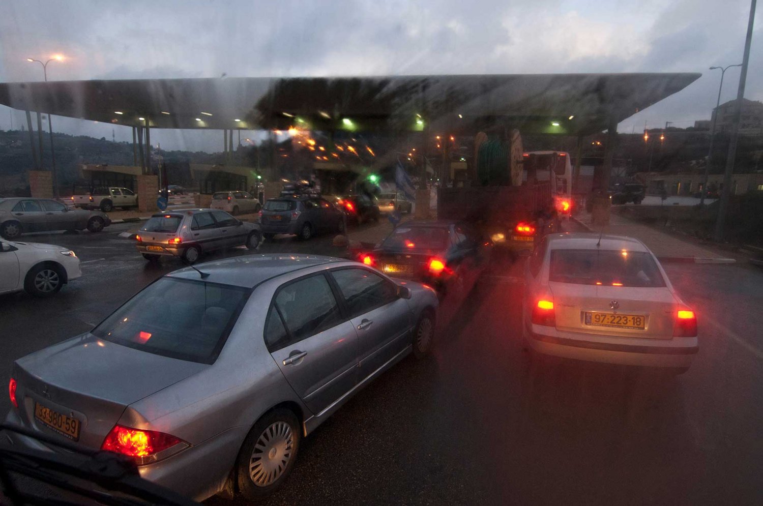 Cars and busses queue at the Qalandiya Israeli checkpoint leading from Ramallah into Jerusalem.