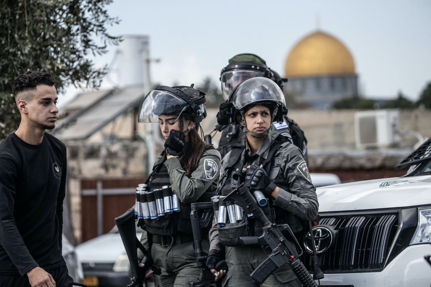 Israeli forces armed to the hilt stand at the ready while Muslims gather to perform Friday prayers in the streets of the Palestinian neighborhood of Ras al-Amud in East Jerusalem, after authorities barred most Muslims from praying at al-Aqsa Mosque. 