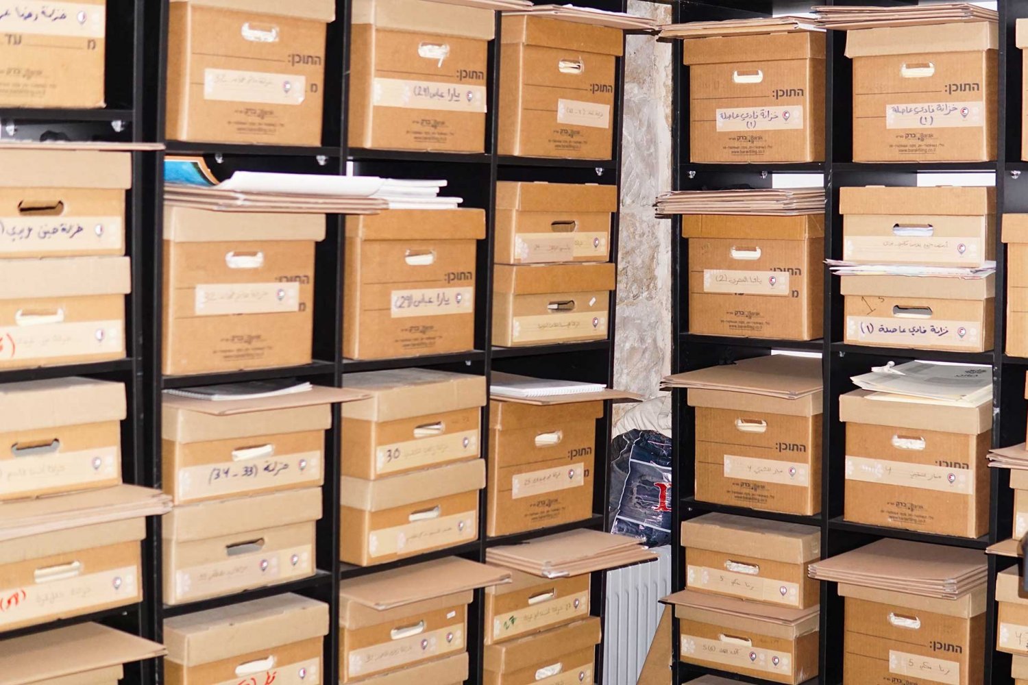 Stacked and labeled boxes filled with artifacts, the filing system of the Khazaaen archive