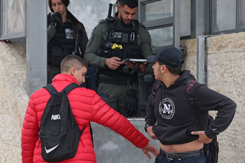 Israeli border guards search Palestinian youths at the Damascus Gate of the Old City of Jerusalem, February 2023. 