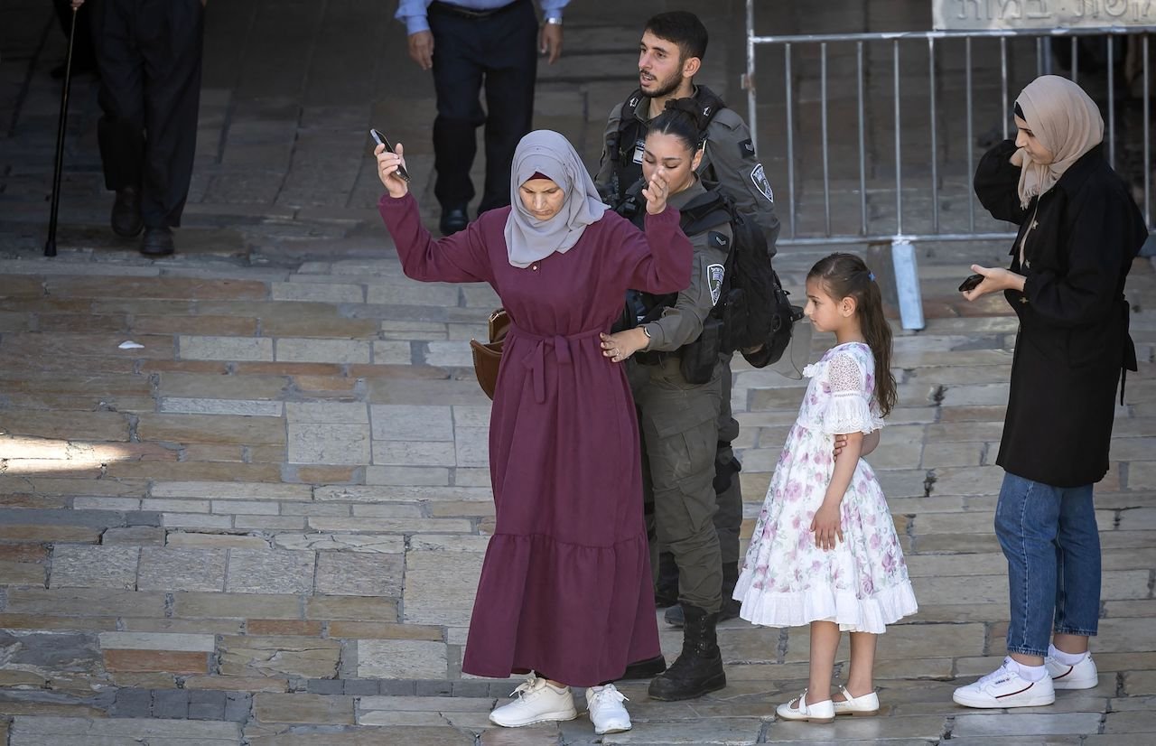 Israeli border police search a mother entering the Old City of Jerusalem through Damascus Gate on November 6, 2023.