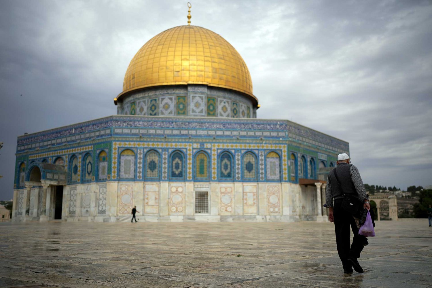 An elderly Palestinian man walks beside the Dome of the Rock in an empty Haram al-Sharif compound on November 12, 2023.