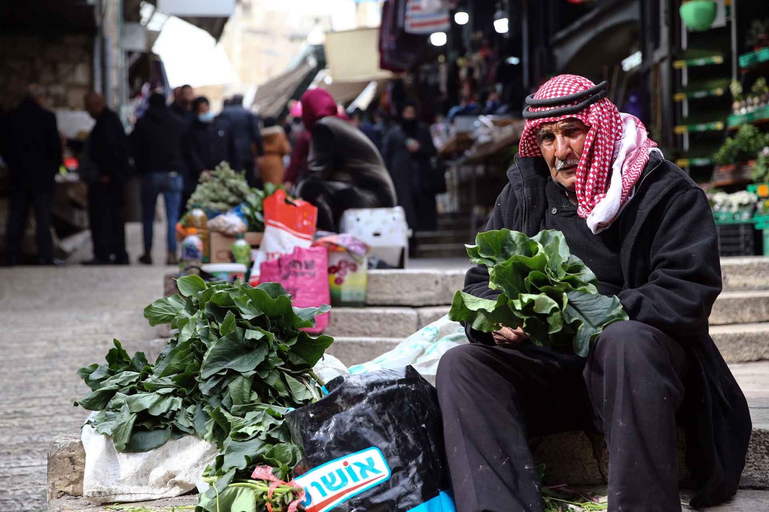 A Palestinian villager sells produce in the Old City of Jerusalem, February 2022.