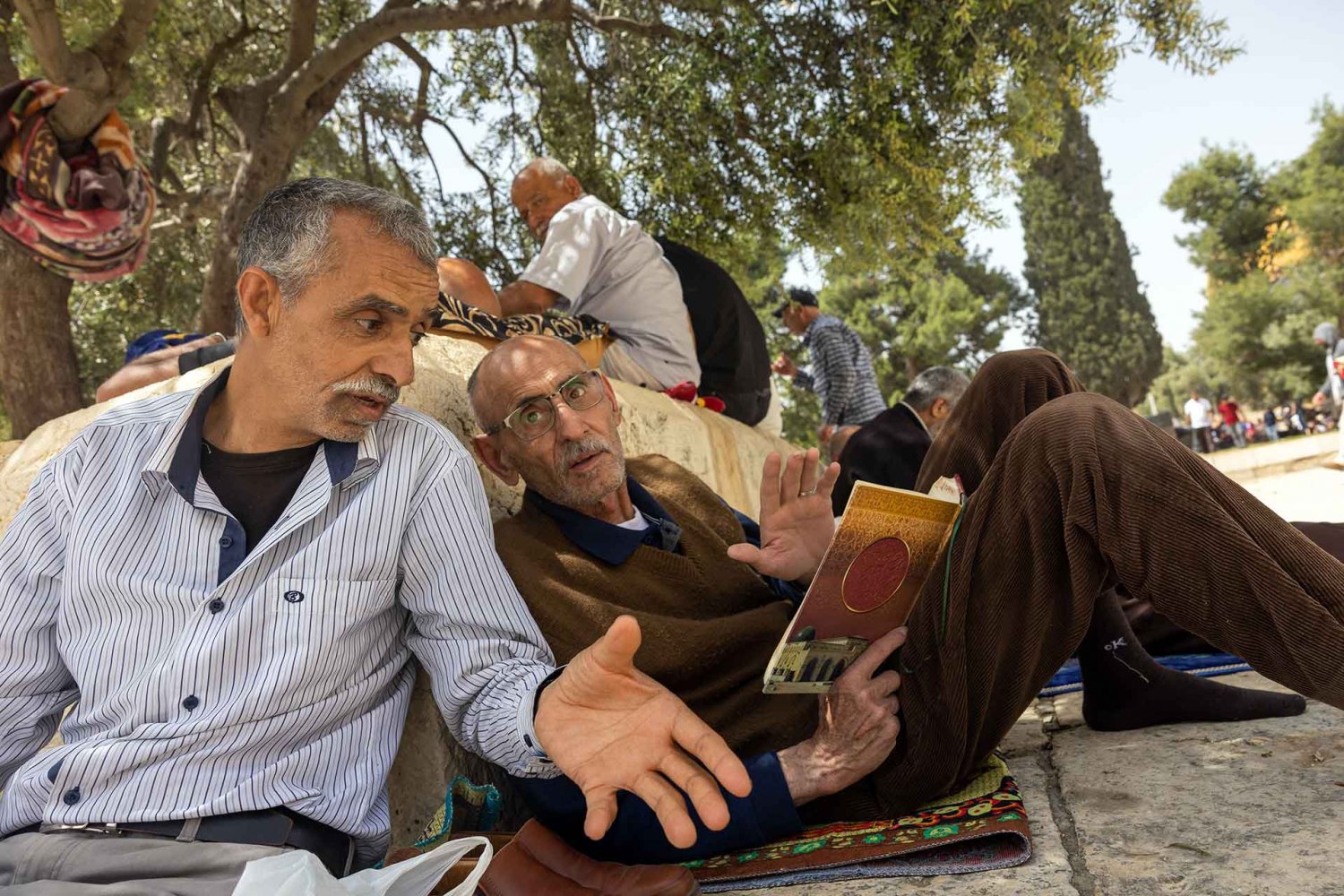 Palestinian Muslims discuss religious texts in the courtyard of al-Aqsa Mosque, Summer 2022