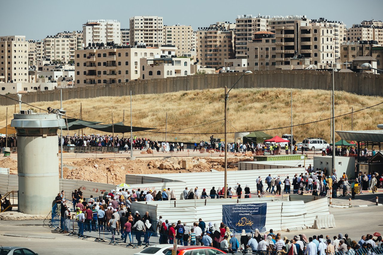 Palestinians wait at Qalandiya checkpoint on May 17, 2019, on their way to pray at the al-Aqsa Mosque in Jerusalem during Ramadan.