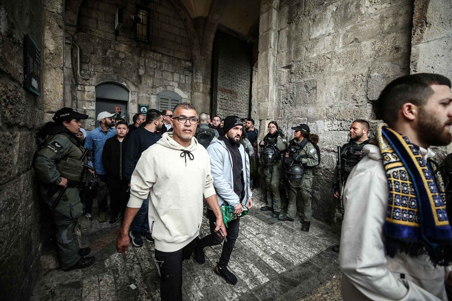 Israeli police stand by and allow young worshippers to proceed to al-Aqsa Mosque on the first Friday of Ramadan, 2024.